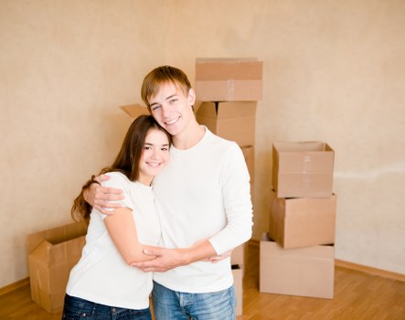 Local Soho removals team handling furniture in a narrow central London building