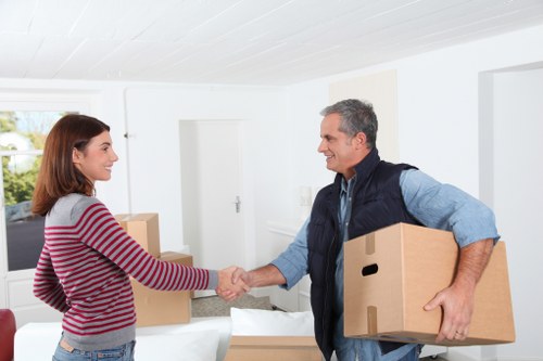 Removal team loading boxes and furniture into a moving van