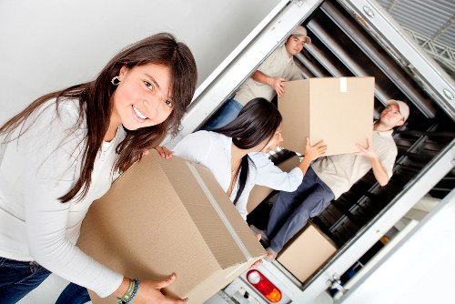 Furniture being carefully carried down stairs in a Soho apartment building