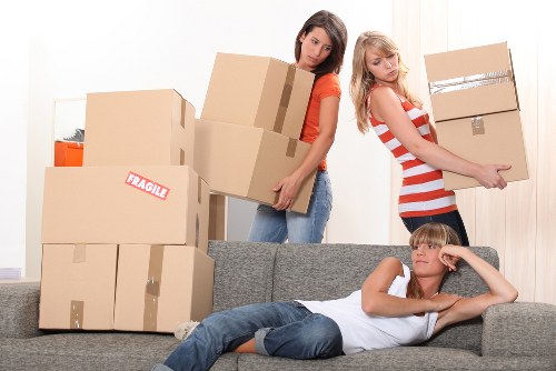 Local removals team handling boxes in central London